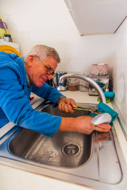 istock Handyman fixing the kitchen faucet 1367236542