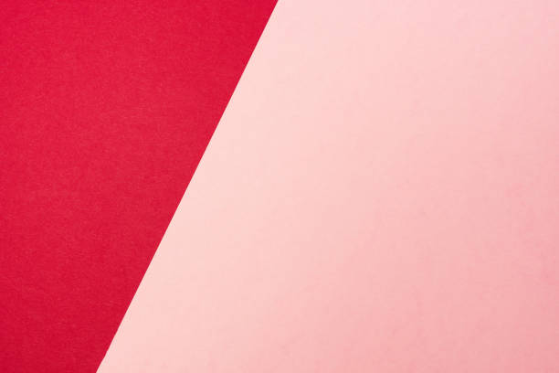 istock Colored paper background. Red and pink paper sheets split on two unequal parts by sloping border. 1367236698