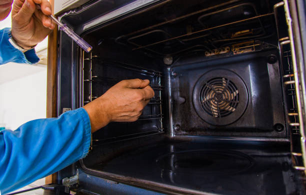 istock Handyman holding screwdriver in the kitchen 1367237568
