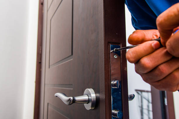 istock Mature handyman fixing the door lock 1367238110