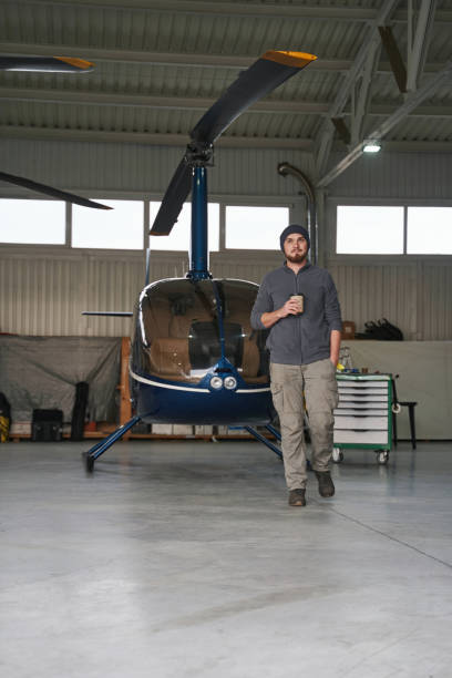 istock Bearded man in front of the copter in garage 1367239169