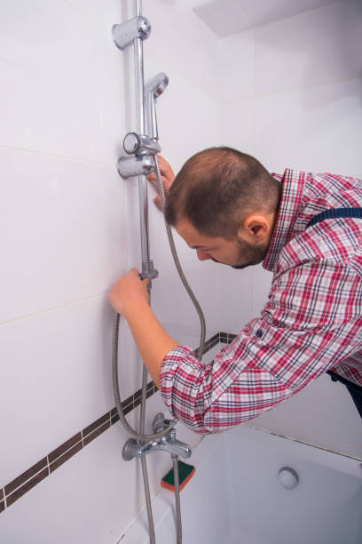 istock plumber install shower head in bathroom 1367239280