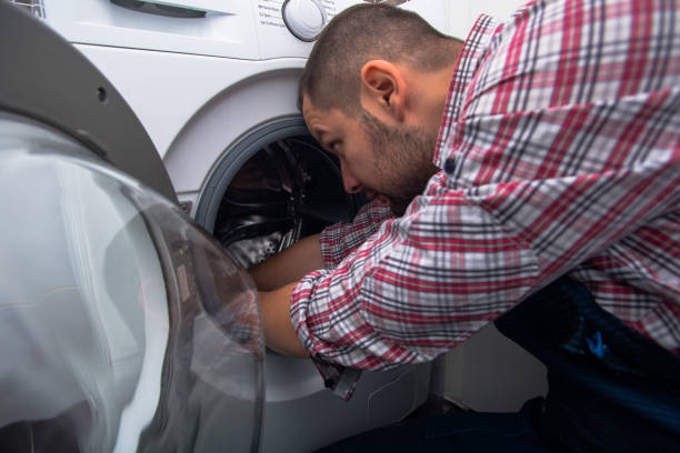 istock Plumber repairing washing machine in bathroom 1367239284