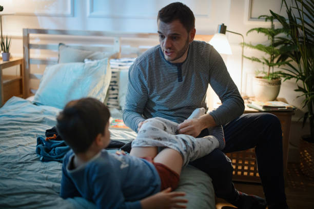 istock The father helps his son put on his pyjamas before bedtime 1367239870