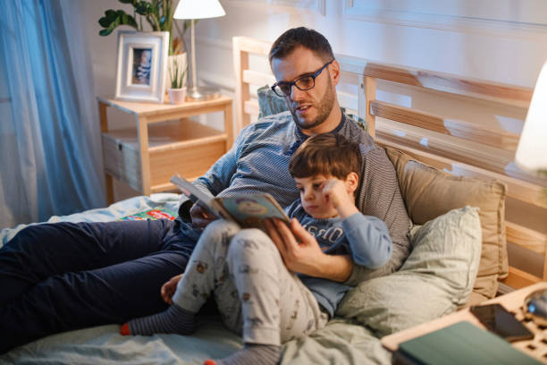 istock Young father reading a bedtime story to his son 1367240095