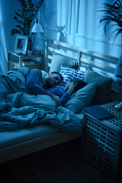 istock Father and son sleeping on the bed 1367240385