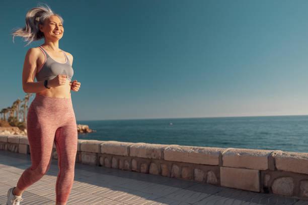 istock Athletic happy woman actively training by the waterfront 1367240491