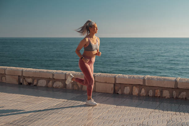 istock Sporty pretty lady jogging by the waterfront 1367240508