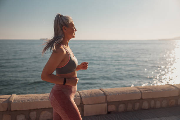 istock Adult strong woman training by the waterfront 1367240510