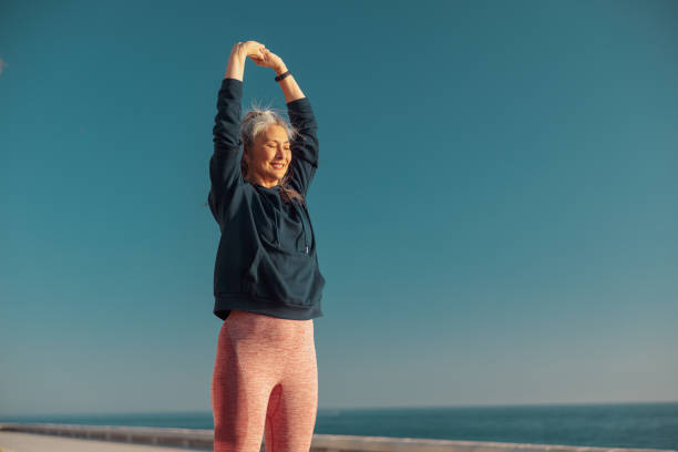 istock Smiling female actively training be the waterfront 1367240545