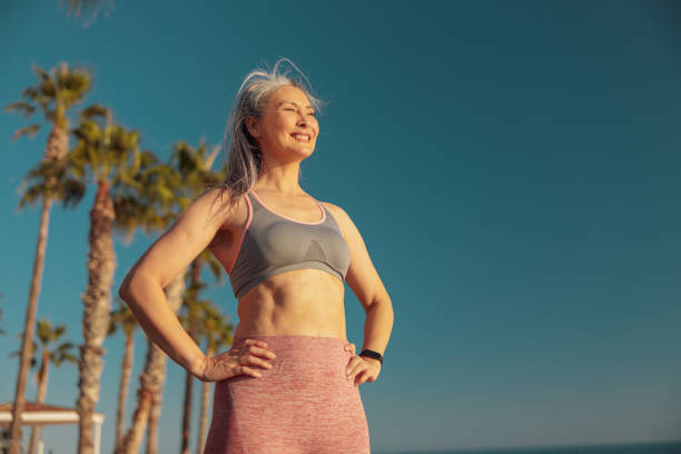 istock Happy motivated woman resting by the waterfront after training 1367240553
