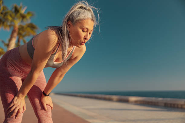 istock Strong lady resting by the coast after hard training 1367240555
