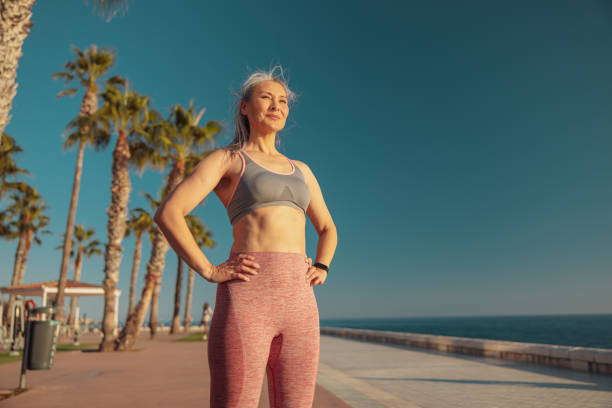 istock Strong pretty woman standing by the waterfront 1367240557