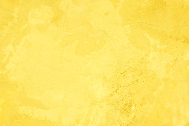 istock Concrete wall yellow color for texture background. Abstract grunge bright colorful color background with growing effect. Pastel yellow colored low contrast textured with roughness and irregularities. 1367242567