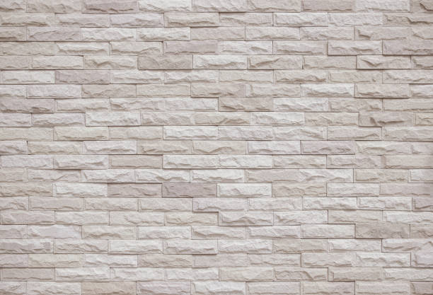 istock Cream and beige brick wall texture background. Brickwork and stonework flooring interior rock old pattern clean concrete grid uneven bricks office design. Background of old vintage brick wall backdrop 1367242686