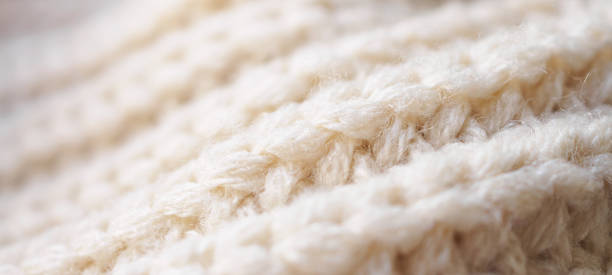 istock closeup beige knitted woolen fabric texture background 1367246459