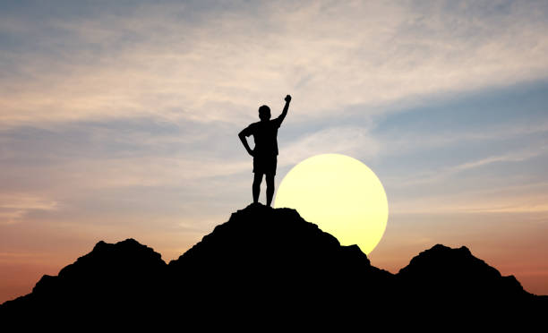 istock Silhouette man On Mountain Sunset Sky 1367246573