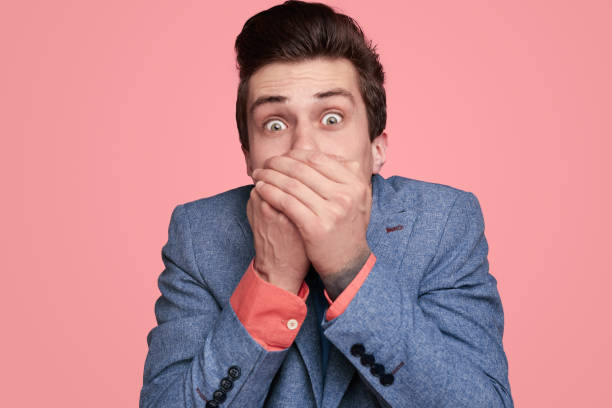 istock Shocked young man covering mouth 1367247143
