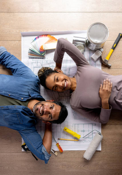 istock Happy couple working on a home improvement project 1367252659