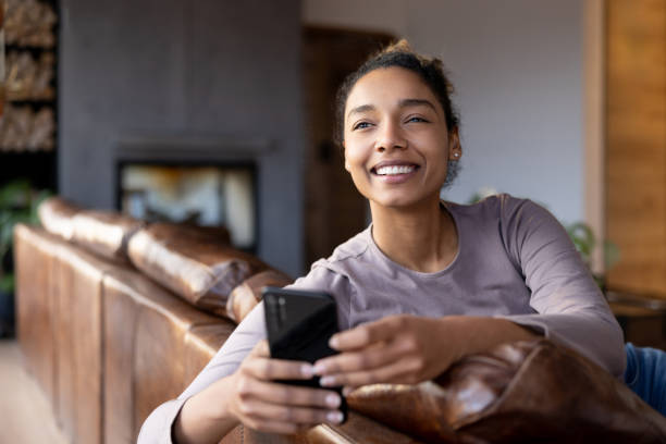 istock Woman relaxing at home using her cell phone 1367252660