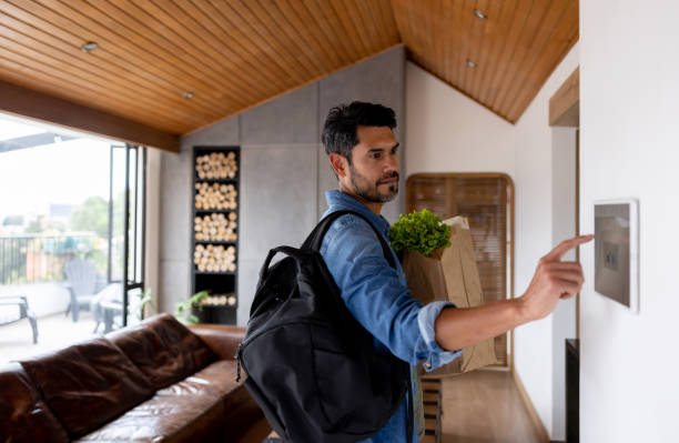 Man arriving to his house and deactivating the alarm using a home automated system
