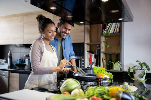 istock Happy couple cooking together at home 1367252802