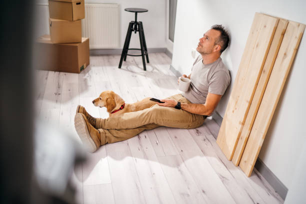 istock a man with his dog moves into a new empty apartment 1367253847