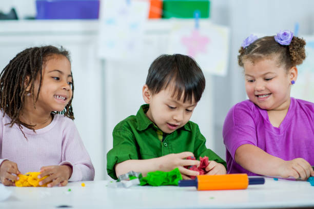 istock Preschool Kids Playing with Playdough 1367258874