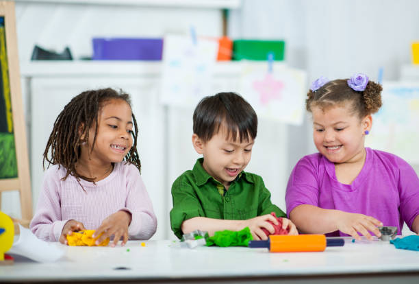 istock Preschool Kids Playing with Playdough 1367258884