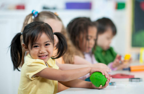 istock Preschool Kids Playing with Playdough 1367258889