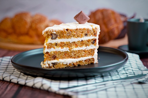 Carrot cake slice with cream cheese frosting. Selective focus