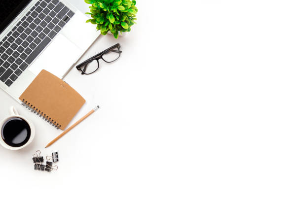 istock White office desk table with blank notebook, computer keyboard and other office supplies. Top view with copy space, flat lay. 1367265111