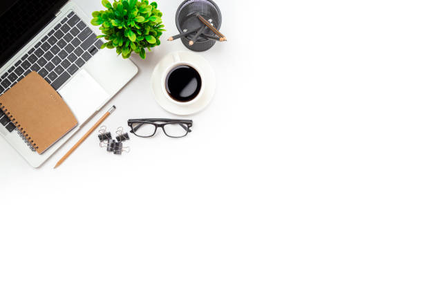 istock White office desk table with blank notebook, computer keyboard and other office supplies. Top view with copy space, flat lay. 1367265117