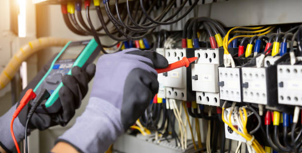 istock Electrician engineer tests electrical installations and wires on relay protection system. Adjustment of scheme of automation and control of electrical equipment. 1367265237