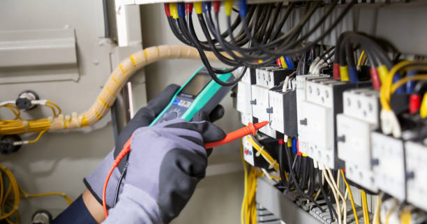 istock Electrician engineer tests electrical installations and wires on relay protection system. Adjustment of scheme of automation and control of electrical equipment. 1367265750
