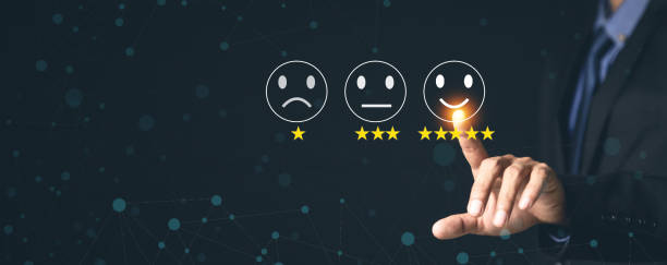 istock Customer Service and Satisfaction Concept Businessmen touch the virtual screen on happy smiley icons to achieve service satisfaction and feedback with excellent rated reviews. 1367265876