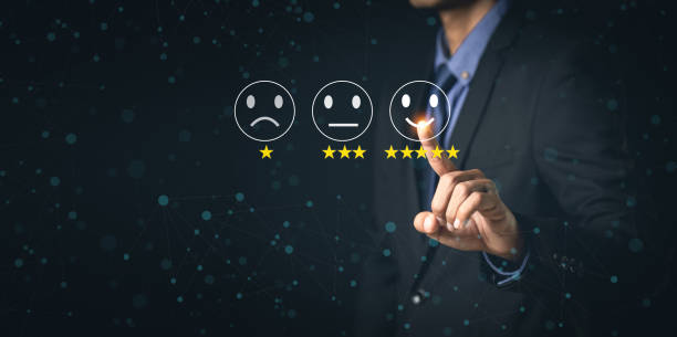 istock Customer Service and Satisfaction Concept Businessmen touch the virtual screen on happy smiley icons to achieve service satisfaction and feedback with excellent rated reviews. 1367265878