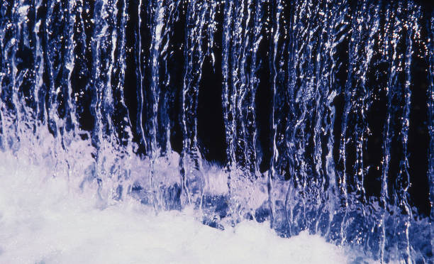 istock Abstract high contrast image of water flowing down a fountain 1367267623