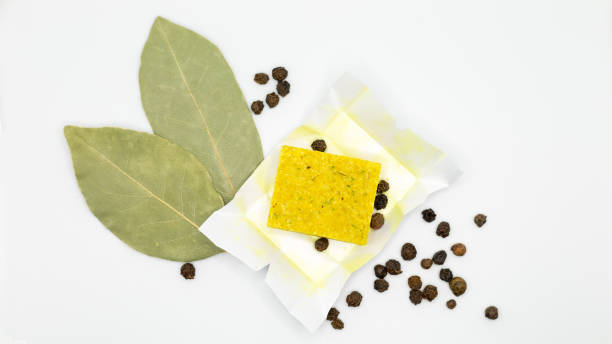 Dry chicken broth with bay leaf and black pepper on a white background, isolated Dry chicken broth with bay leaf and black pepper on a white background, isolated. stock cubes stock pictures, royalty-free photos & images