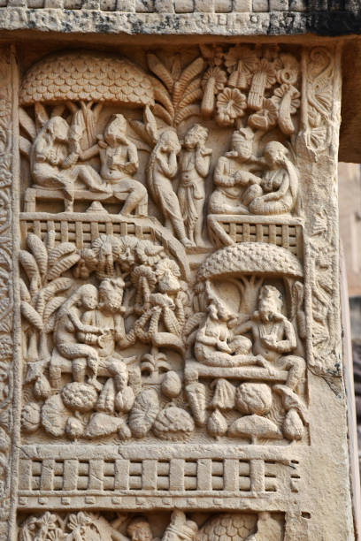 istock Stupa No 1, West Gateway, Left Pillar, Front Face , Panel 2 : Couples are seen talking and engaged in amorous activities in a garden.  World Heritage Site, Sanchi, Madhya Pradesh, India 1367276583