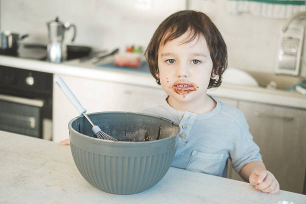 istock The little boy was smeared with chocolate mixture. 1367276722