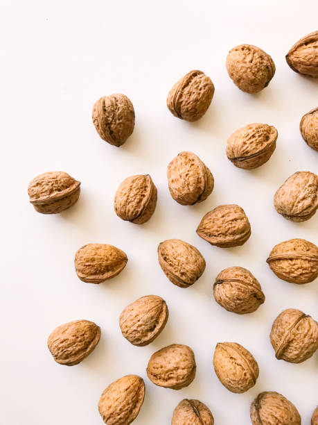 istock A handful of walnuts in a shell close-up, a set of walnut shells on a white background 1367278062