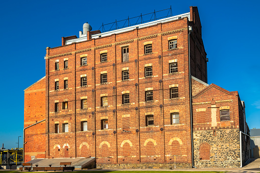 Old Hart's Mill building lit up by the afternoon sun in Port Adelaide, South Australia