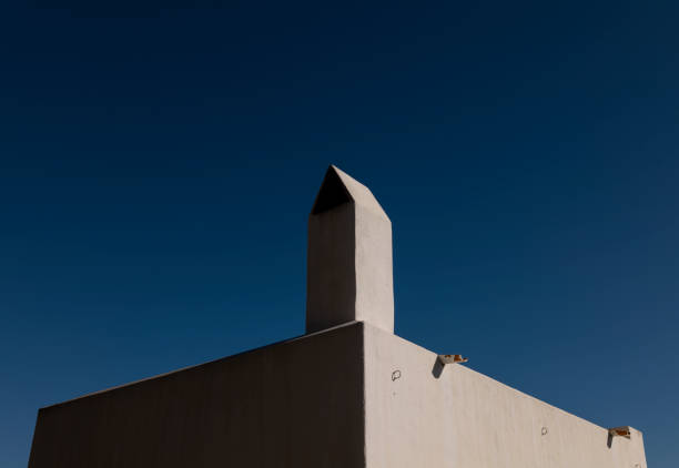 White building with chimney against blue sky. Almeria, Spain