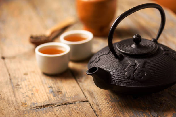 Traditional asian tea Traditional japanese herbal tea recipe prepared in cast iron teapot with organic dry herbs. oolong tea stock pictures, royalty-free photos & images