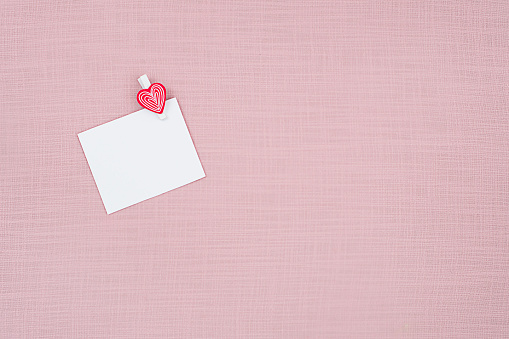 blank sheet of paper on a pink background, concept Valentine's Day