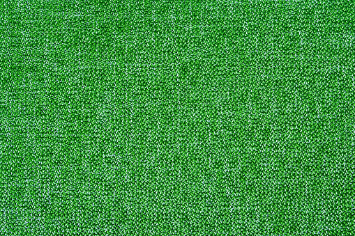A pattern of green matting fabric as a background for the design. Abstract texture of natural fabric.