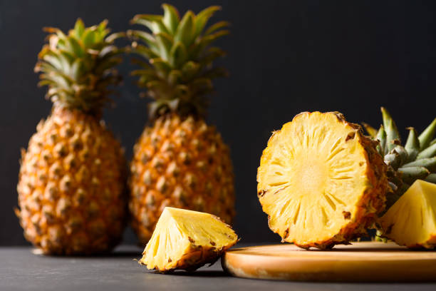 istock Pineapple from local market on black background 1367286398