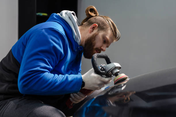 istock Car headlight cleaning with power buffer machine at service station 1367287514
