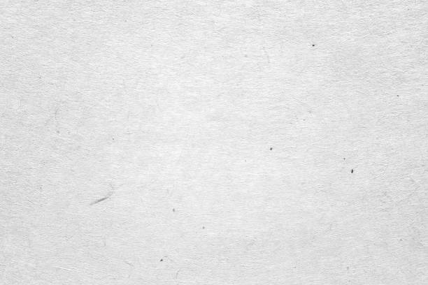 istock White paper or cardboard texture with black spot background. 1367291247
